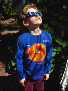 Boy wearing eclipse glasses.