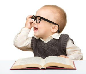 Baby reading and wearing glasses